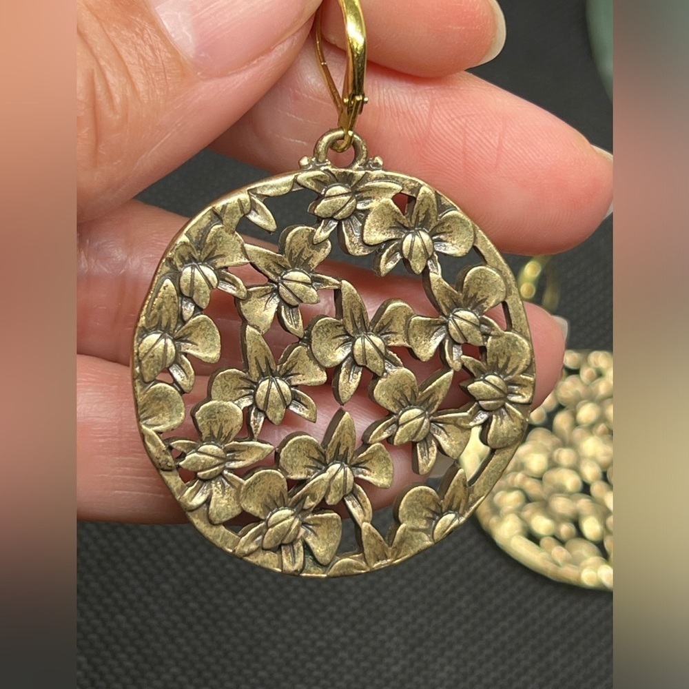 Vintage brassy toned orchid collage round dangle earrings.